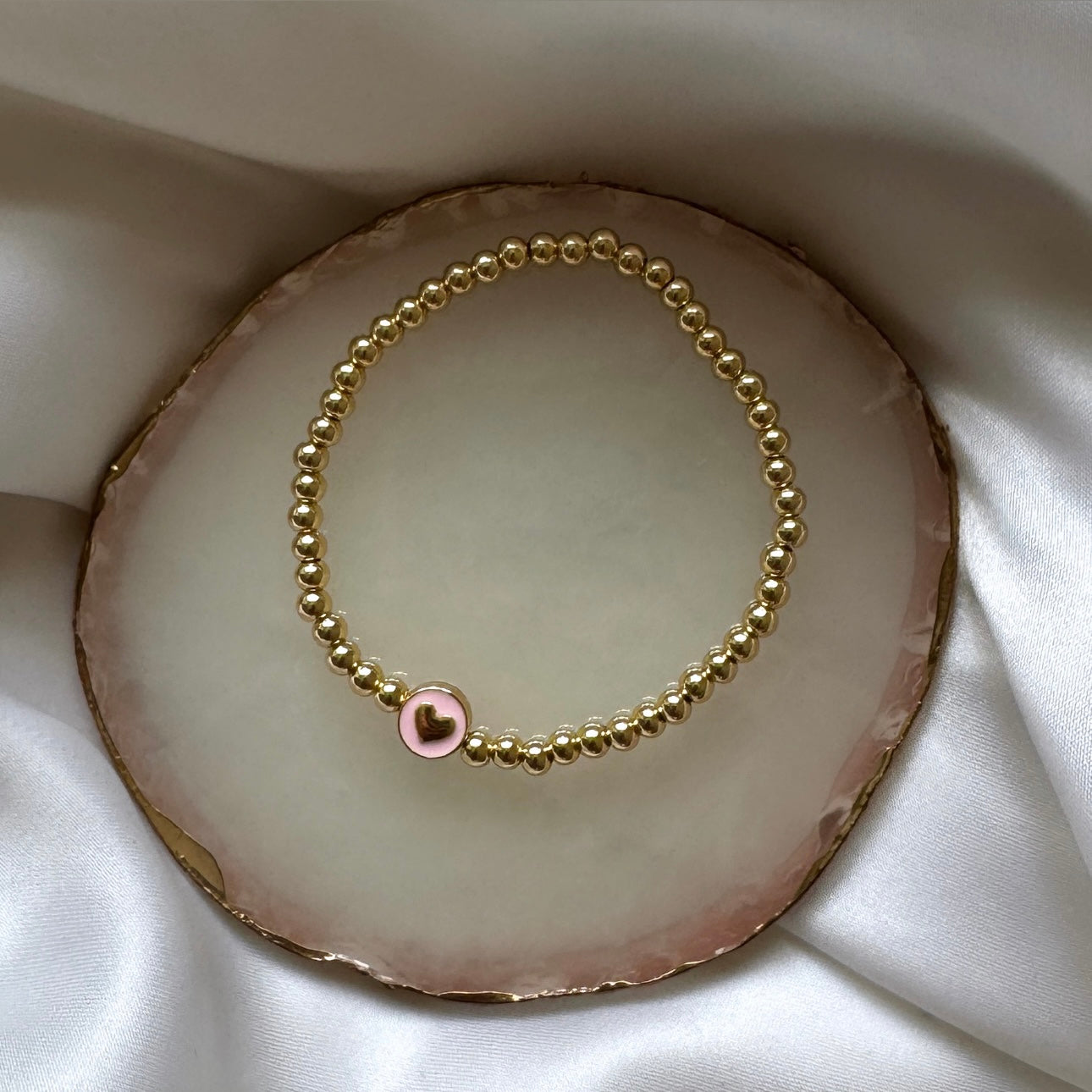 Pink and gold heart disc bracelet