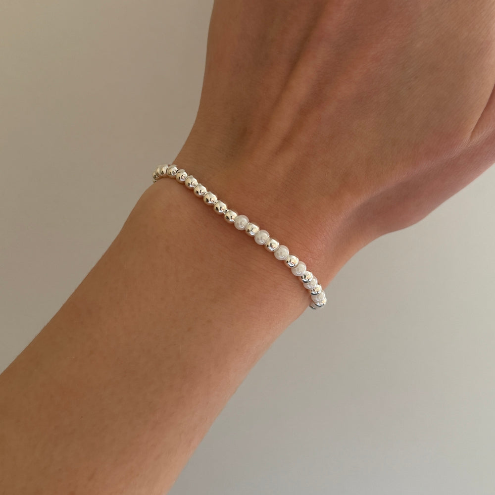 
                      
                        Silver and pearl simple stacking bracelet
                      
                    