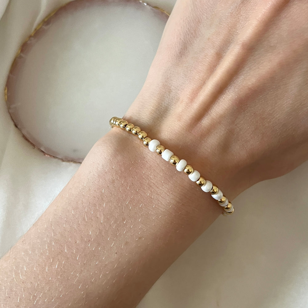 
                      
                        Gold and pearl simple stacking bracelet
                      
                    