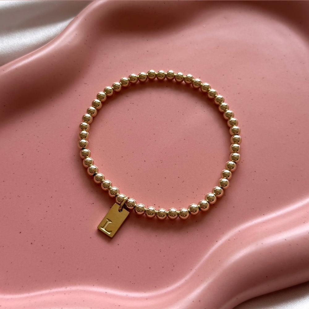 
                      
                        14kt Gold Filled Engraved Initial Tag Bracelet - Positively Beaded
                      
                    