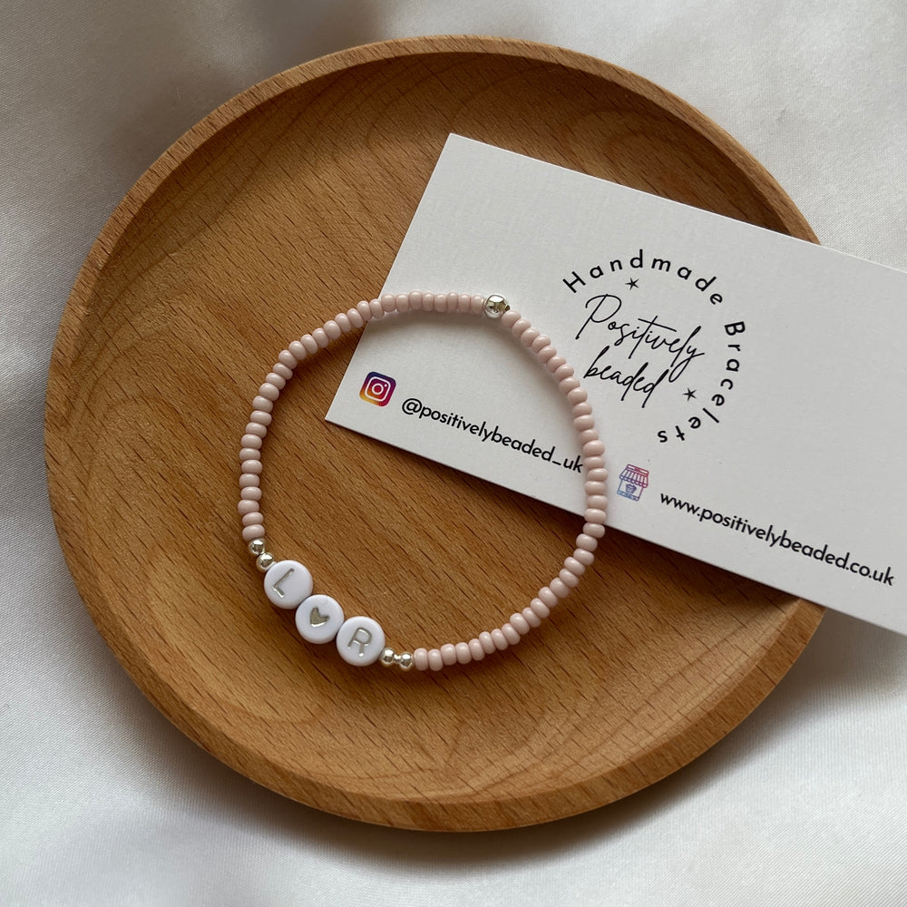 
                      
                        Minimalist neutral initial bracelet - Positively Beaded
                      
                    