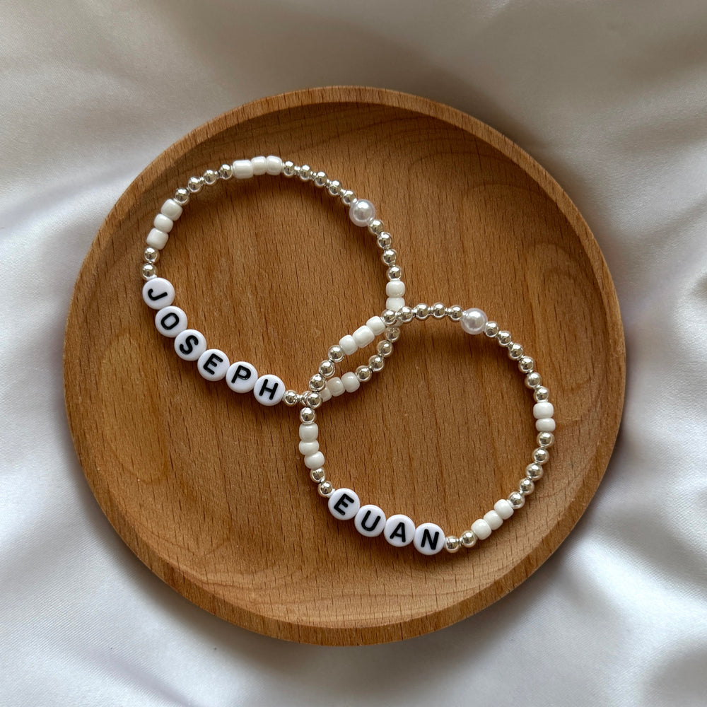 
                      
                        Pearl and silver name bracelet
                      
                    