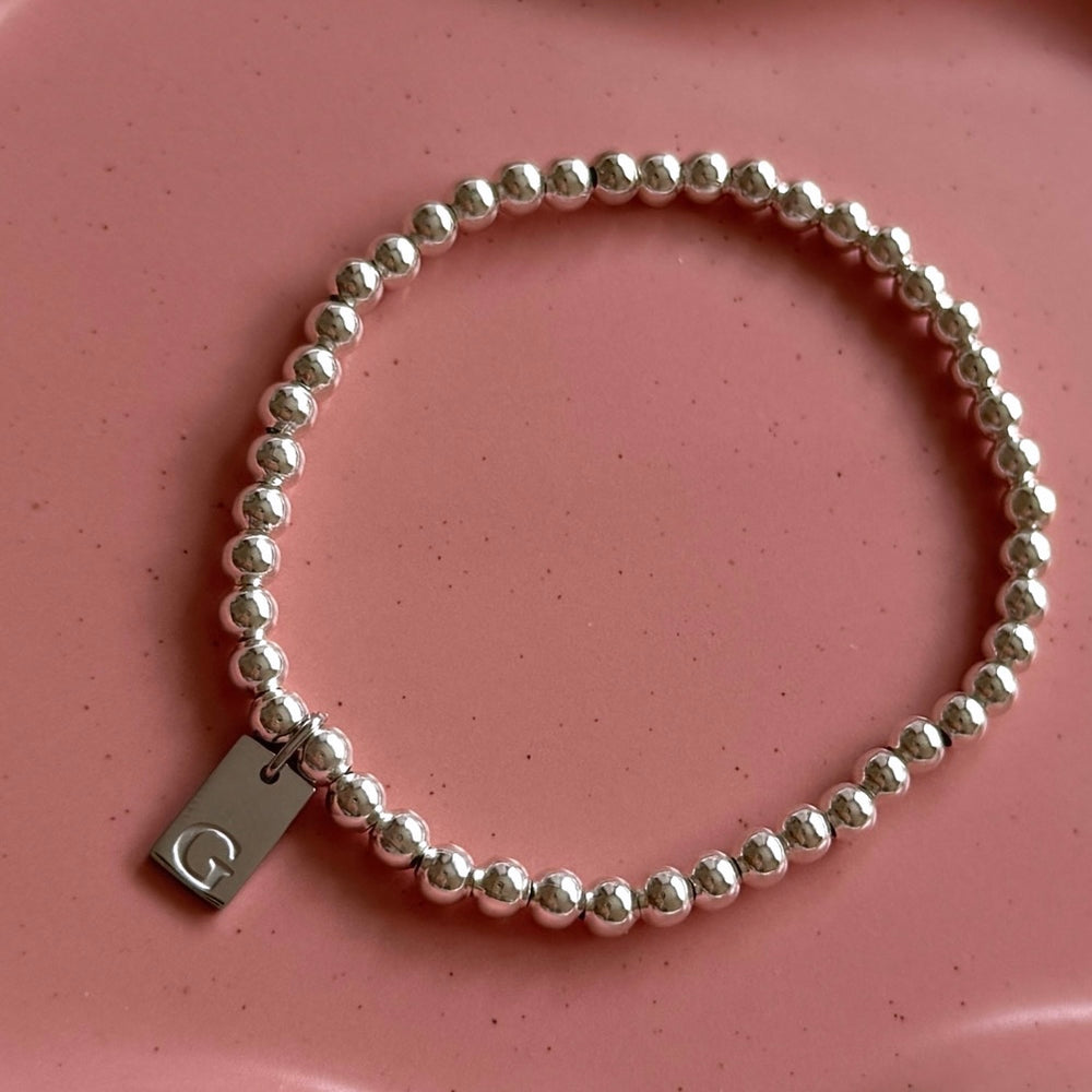 
                      
                        Silver Plated Engraved Initial Tag Bracelet - Positively Beaded
                      
                    