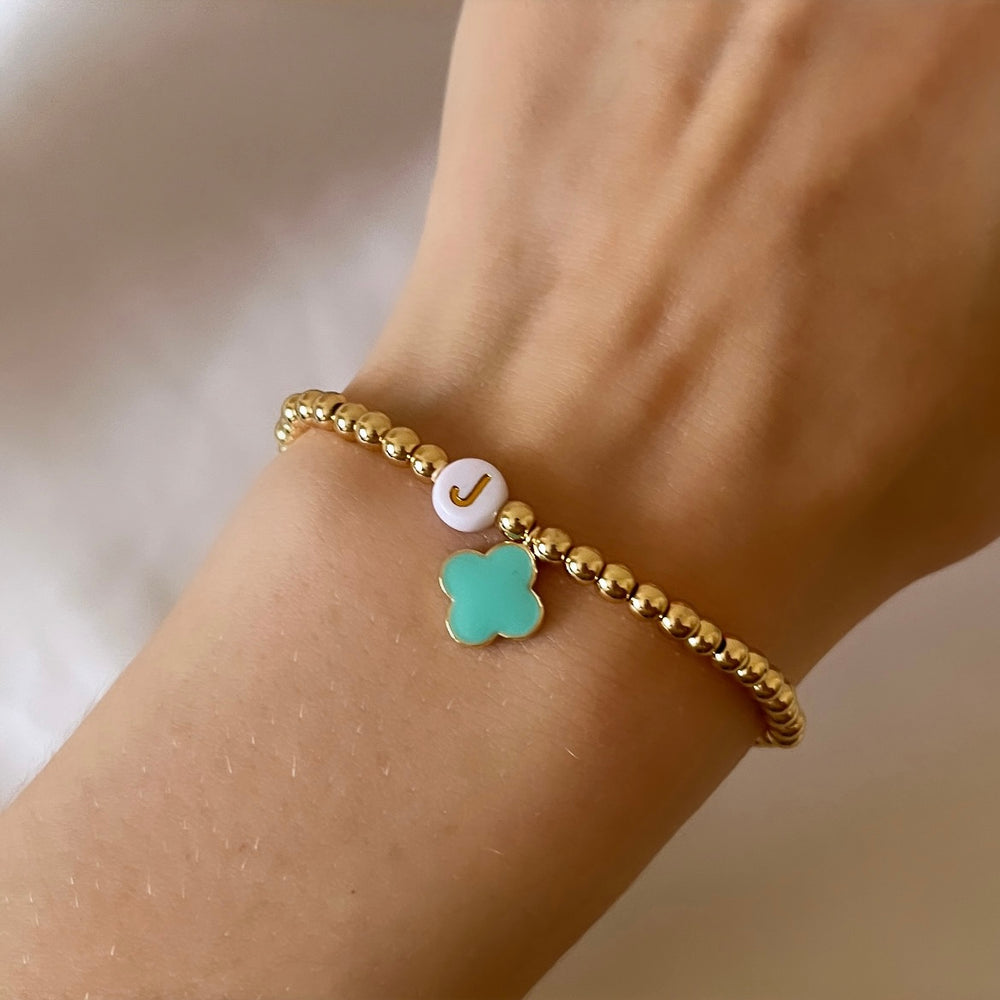 
                      
                        Gold clover charm initial bracelet
                      
                    