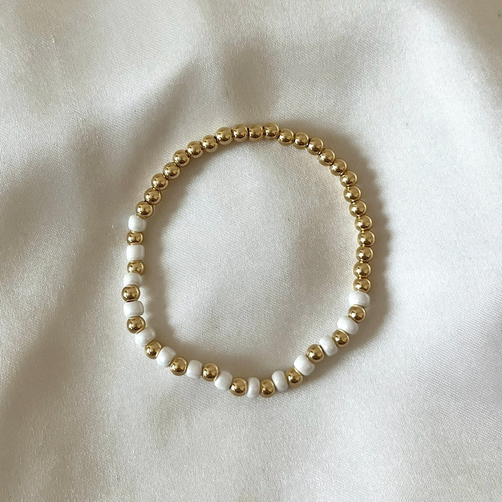 
                      
                        Gold and pearl simple stacking bracelet
                      
                    