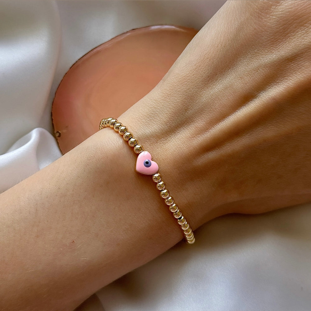 Pink and gold evil eye heart bracelet