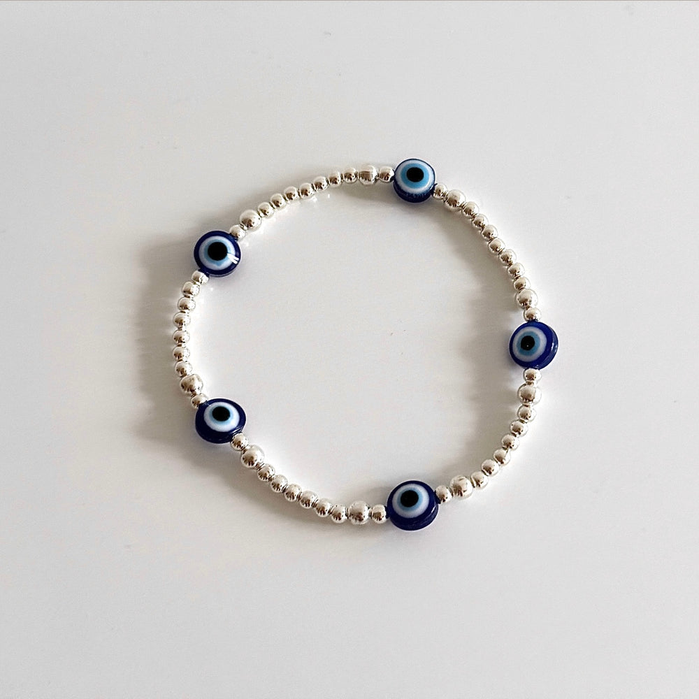 
                      
                        Blue and gold evil eye bracelet pictured on its own
                      
                    