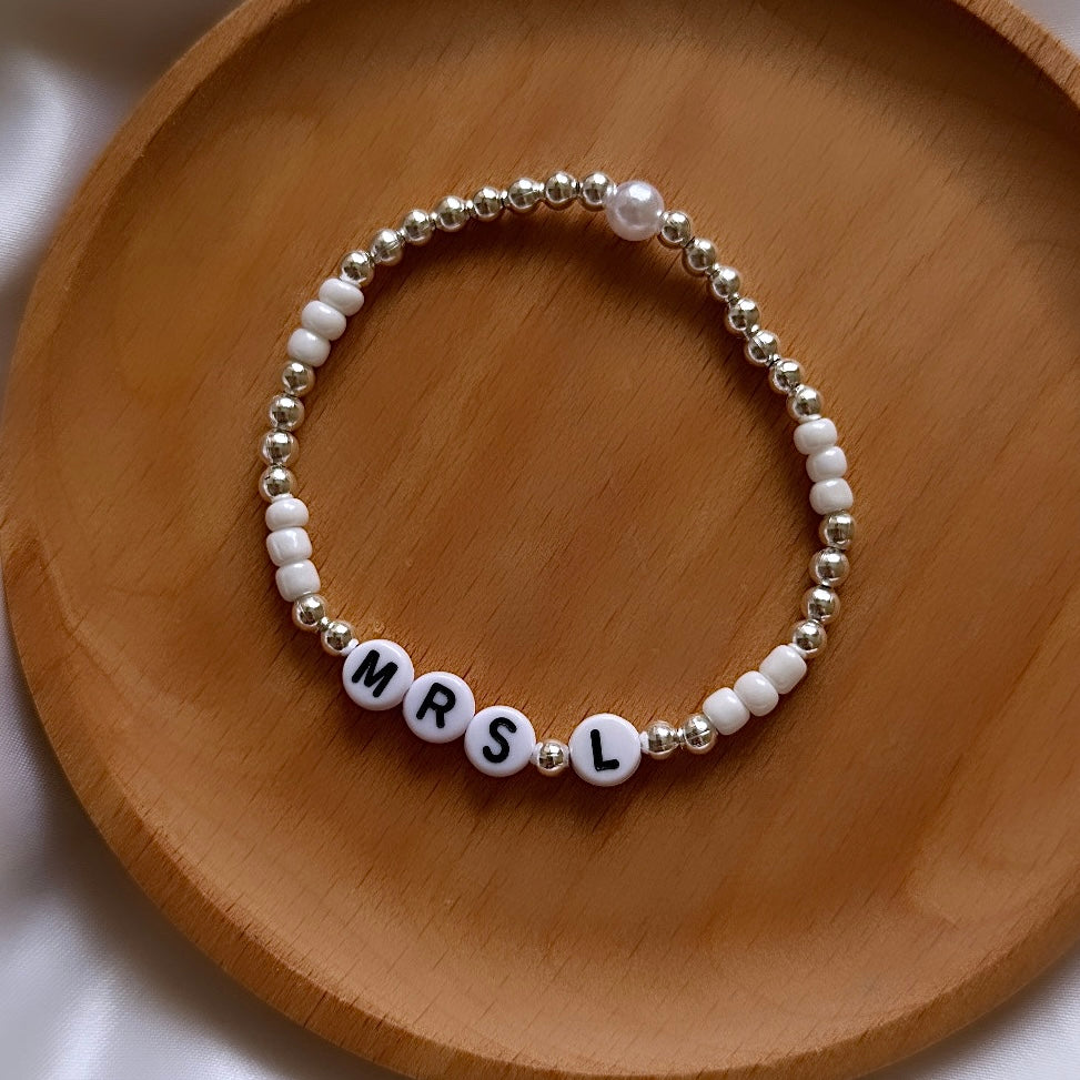 
                      
                        Pearl and silver name bracelet
                      
                    