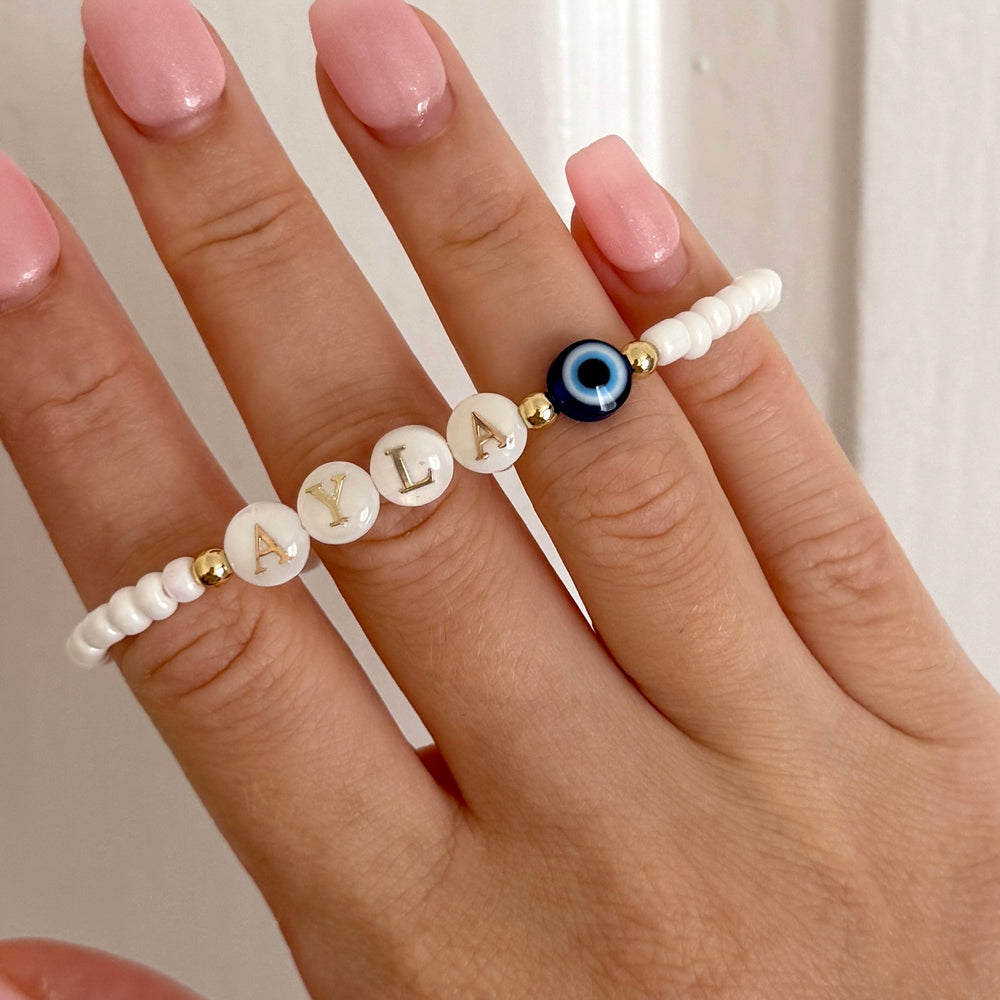 
                      
                        Freshwater pearl evil eye name bracelet - Positively Beaded
                      
                    