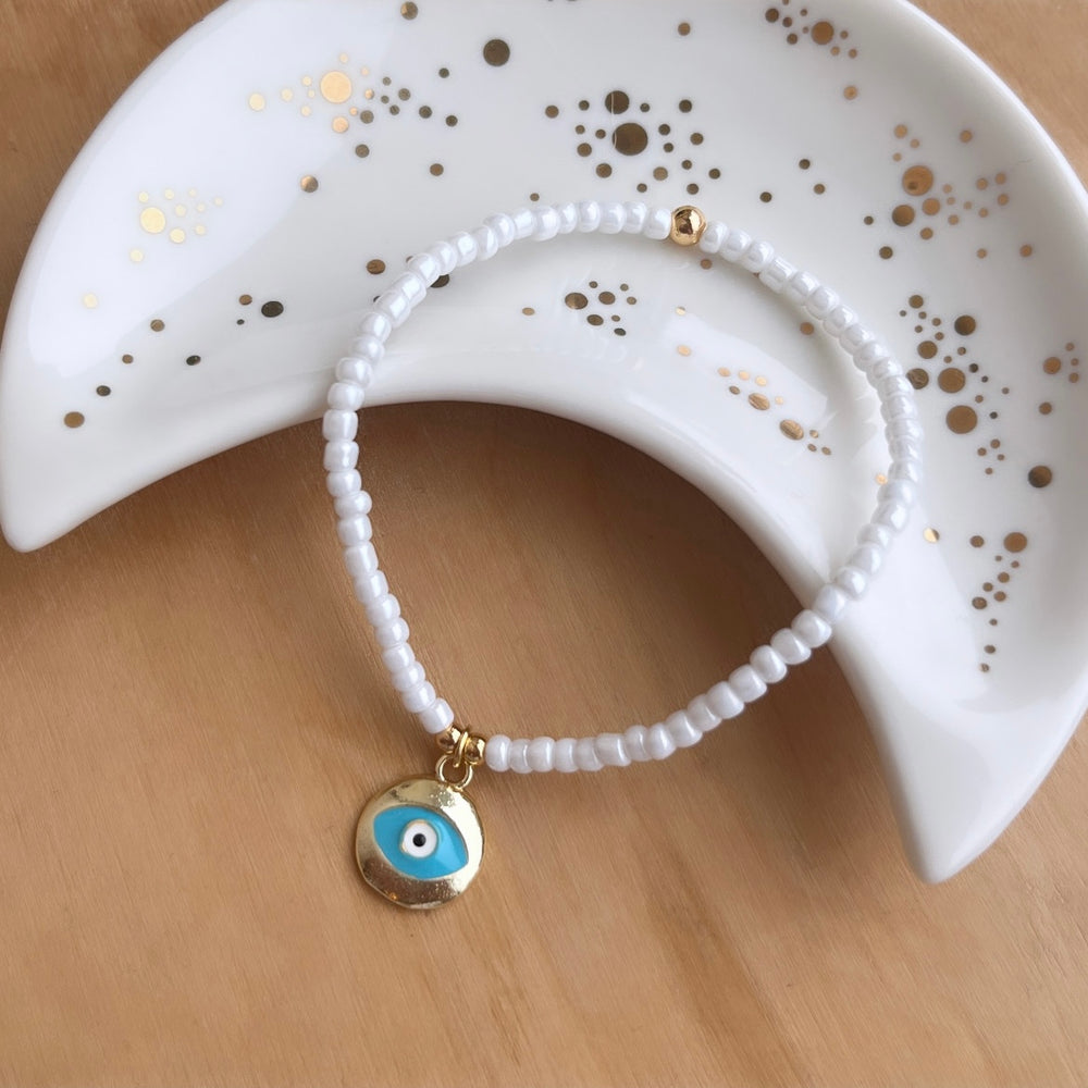 
                      
                        Gold and white evil eye charm bracelet - Positively Beaded
                      
                    