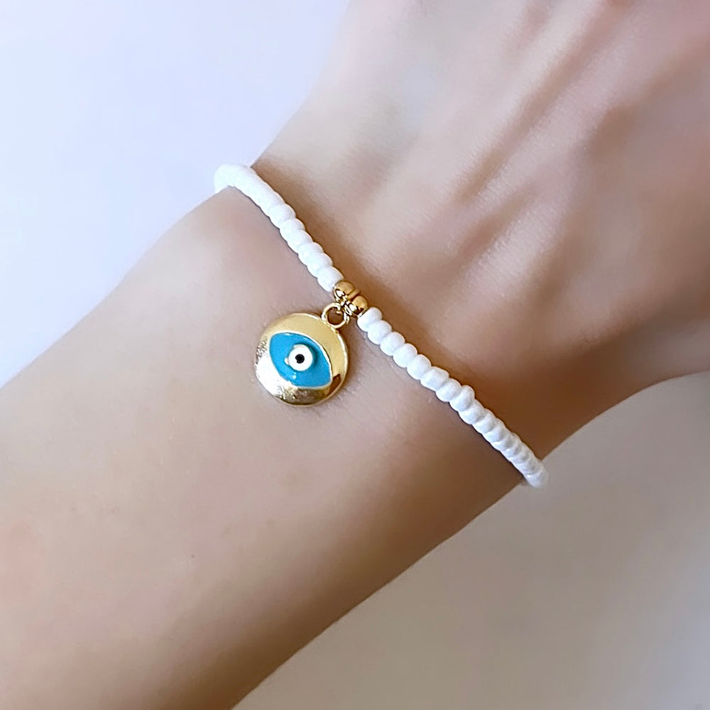 
                      
                        Gold and white evil eye charm bracelet - Positively Beaded
                      
                    