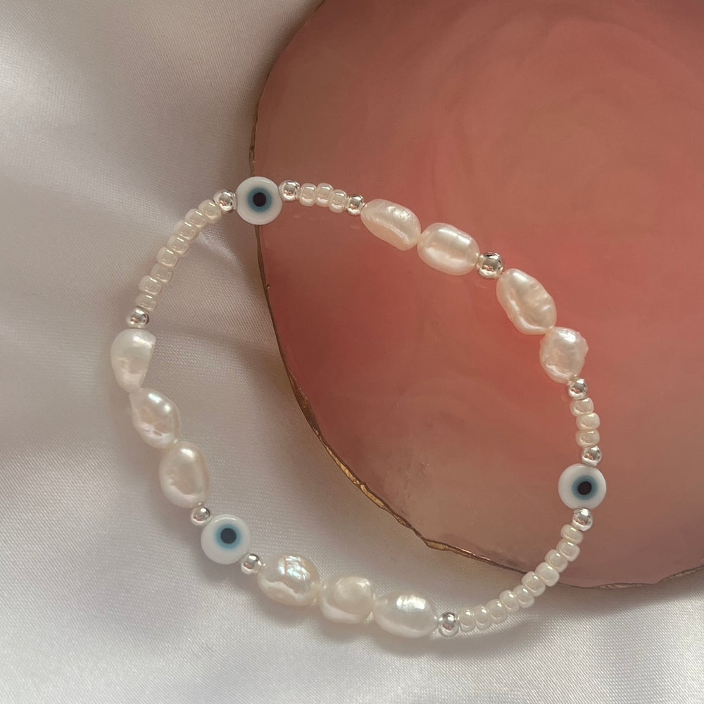 Light blue evil eye and pearl bracelet