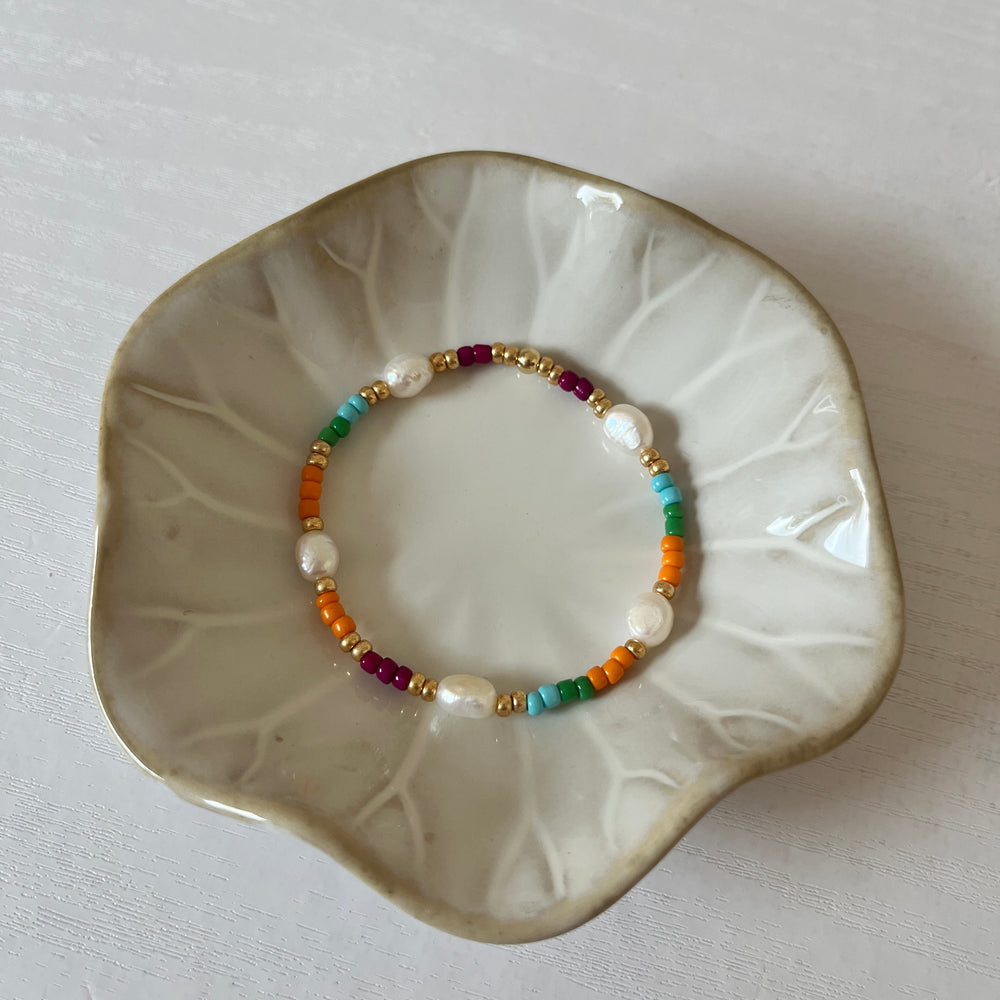 
                      
                        Colourful pearl and gold bracelet
                      
                    